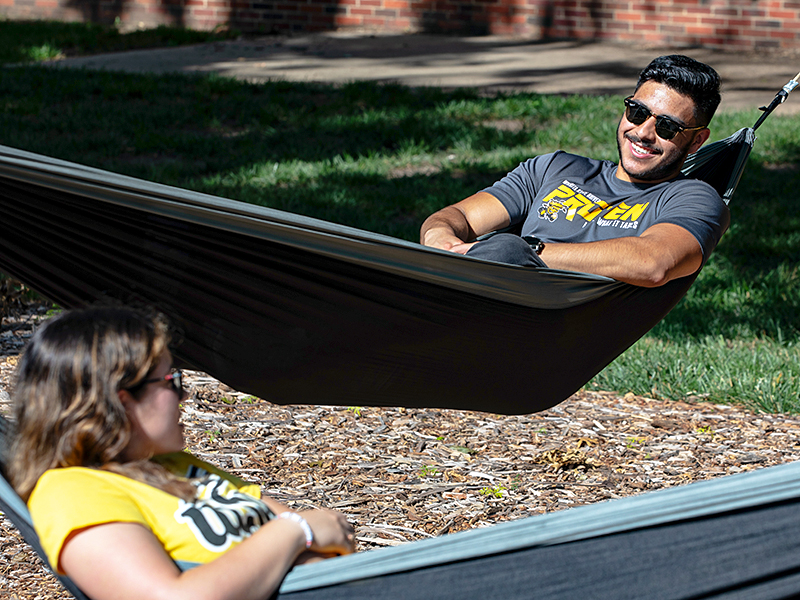 Students enjoying Wichita State's hammock lounge.