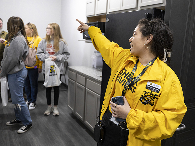 Andrea Hernandez shows a tour room at The Suites.