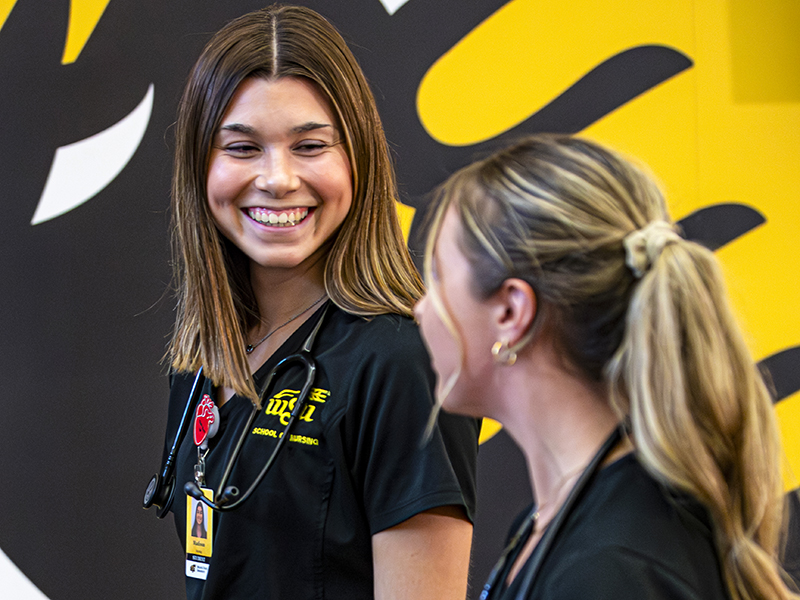 Madison McClain talks with a fellow nursing student at Wichita State.