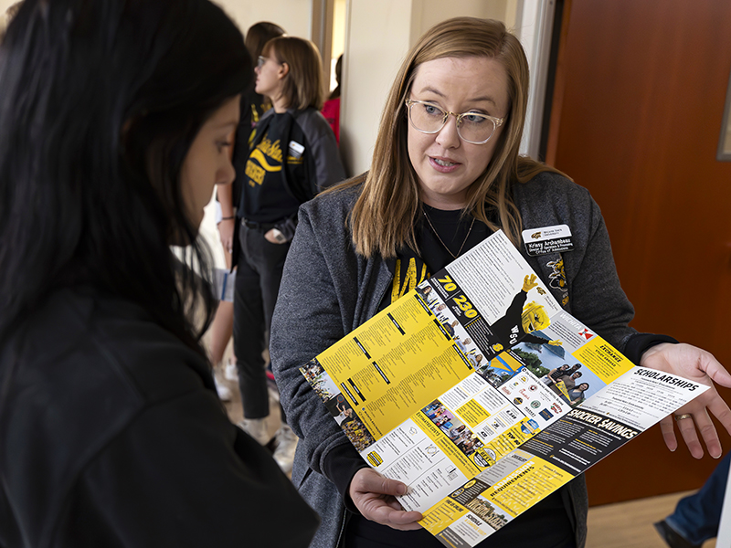Krissy Archambeau, Director of Operations & Processing for the Office of Admissions, assists a prospective student during the Oct. 20, 2023 Black & Yellow Day. 