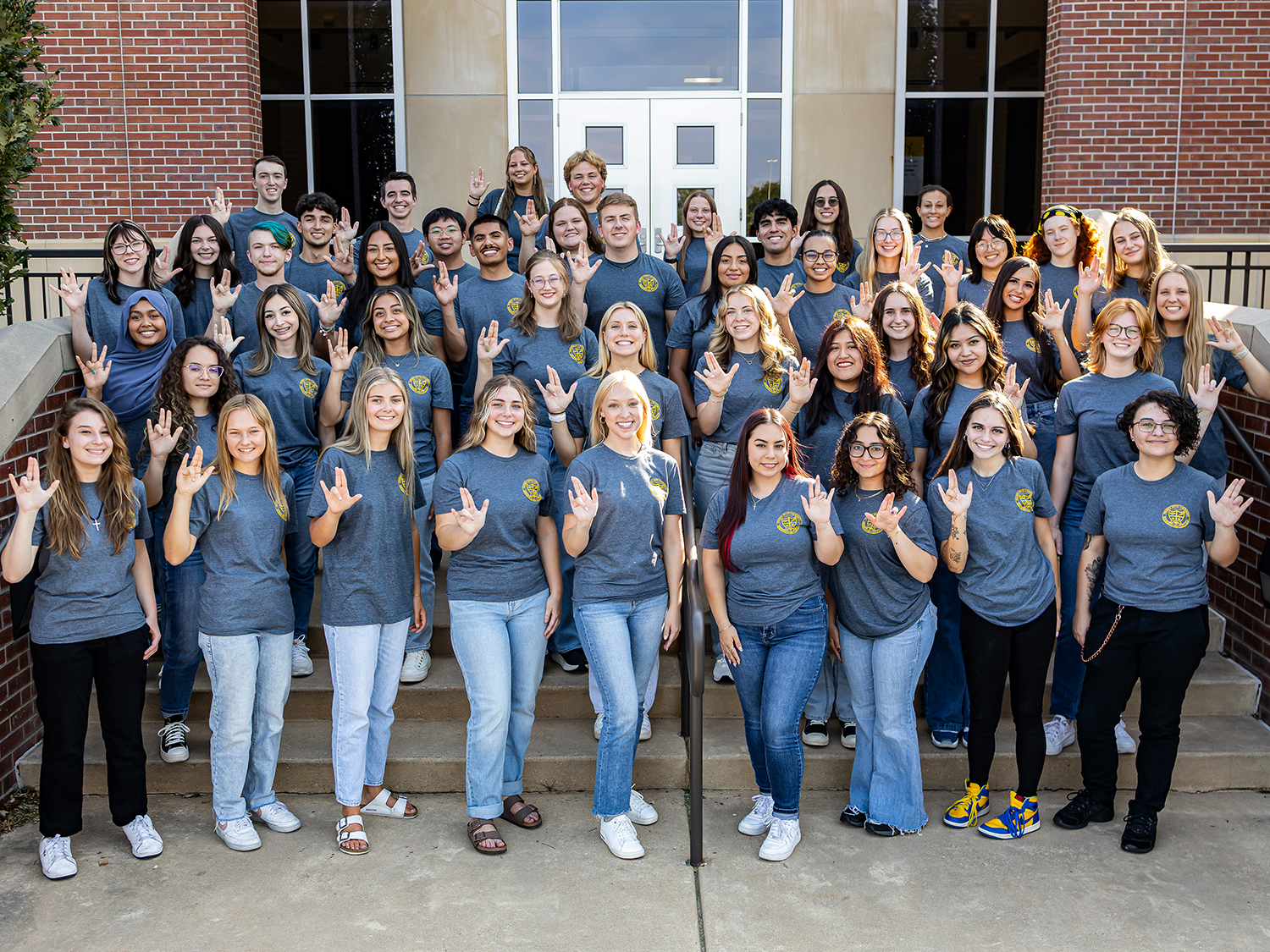 The 2024025 class of the Student Ambassador Society poses for a group photo outside of the Marcus Welcome Center.