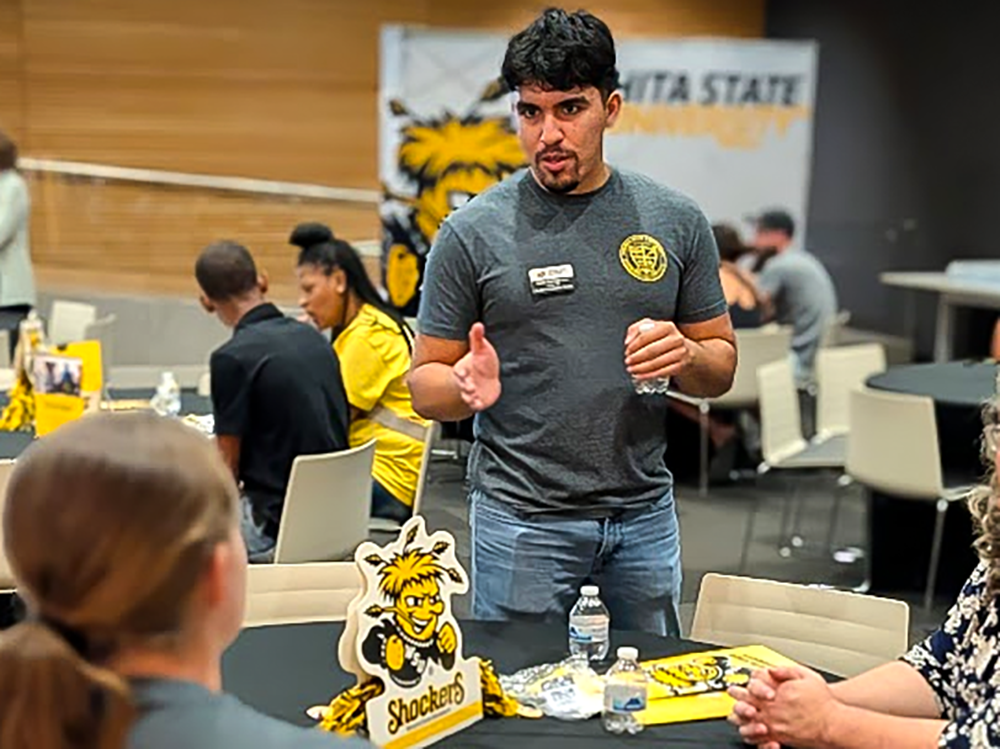 Samir Barraza talking with a prospective student during Discover Wichita State in Tulsa, Oklahoma