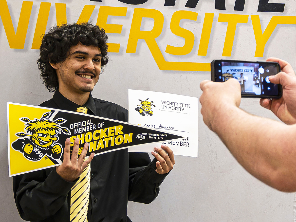 Carlos, Class of 2025, smiles for a photo at Wichita State's signing booth during W-S-YOU.