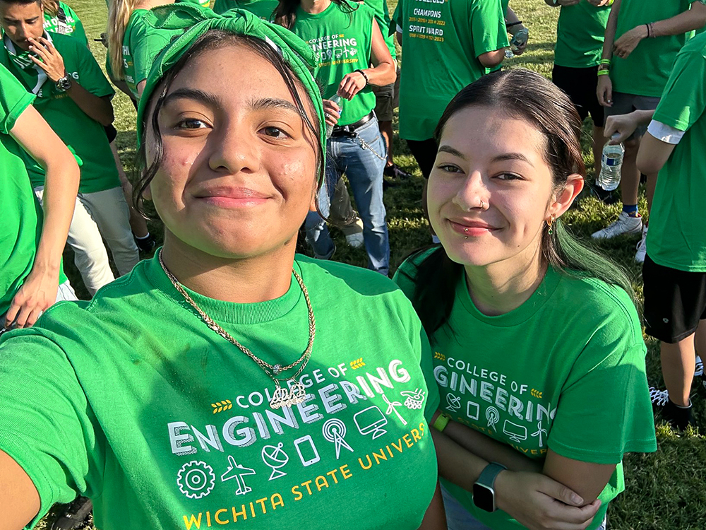 Yuridia Abrego, left, decked out in green for the College of Engineering during Clash of the Colleges.