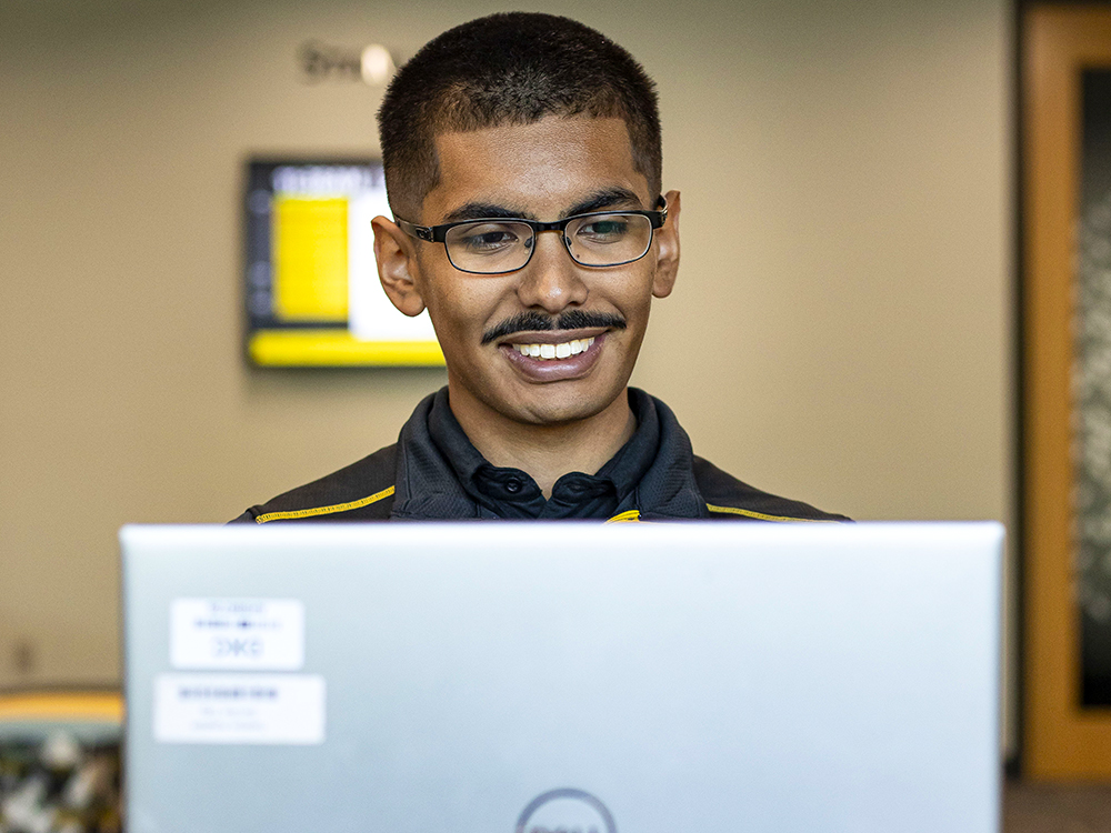 Israel Torres on a computer in Woolsey Hall.