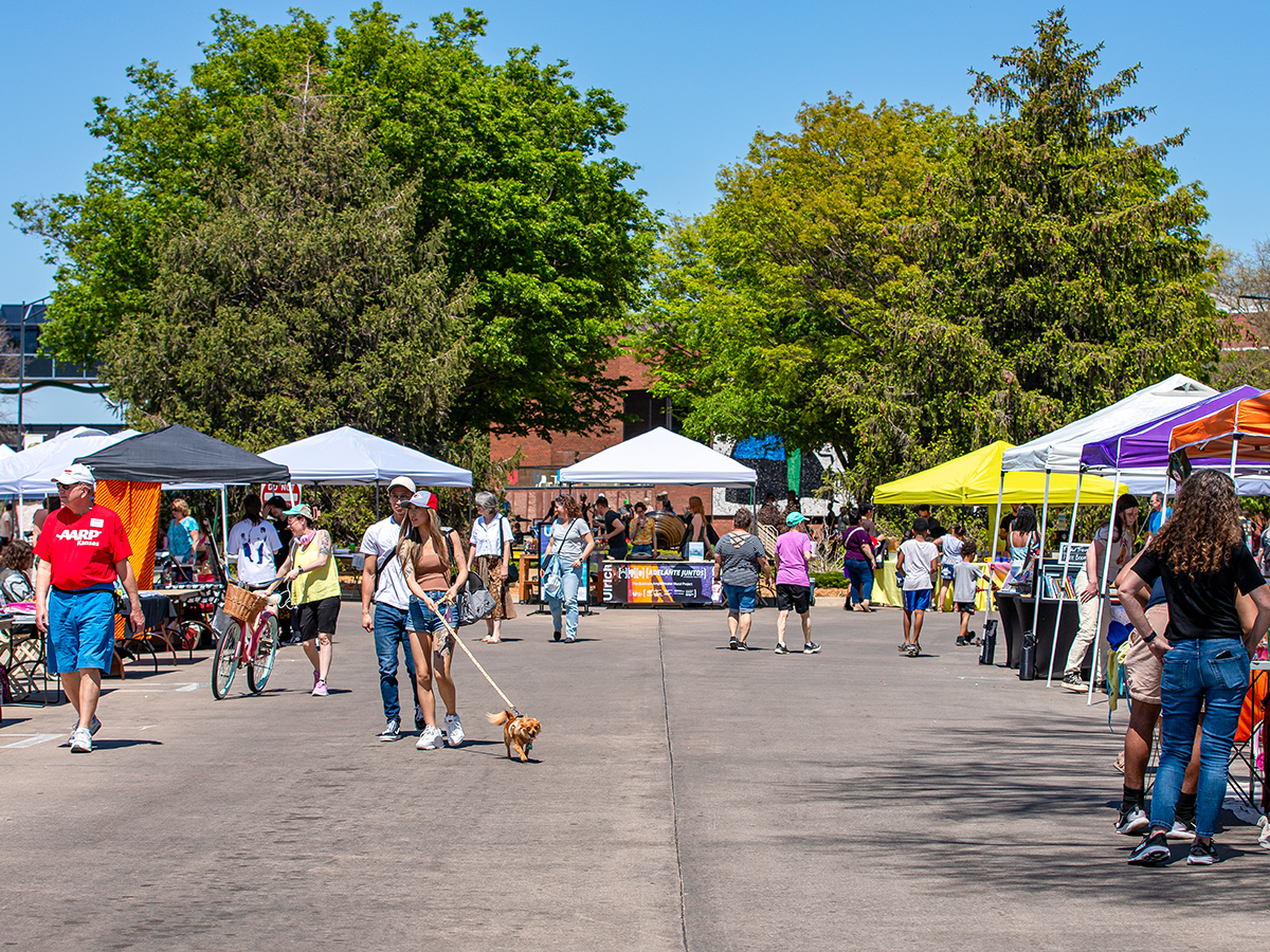 People checking out the vendors in the Fine Arts keyhole drive at Wichita State University during Open Streets ICT.