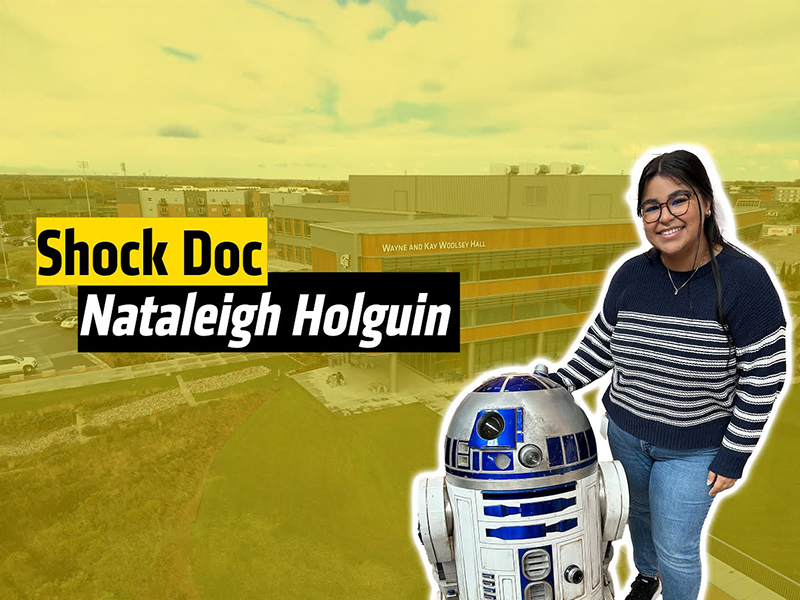 Nataleigh poses beside a replica of R2D2.