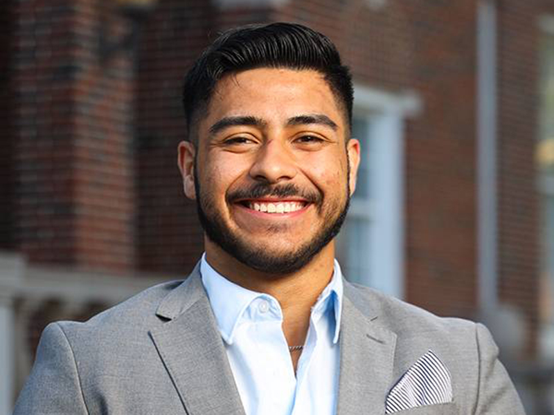 Rafael poses in front of Morrison Hall.