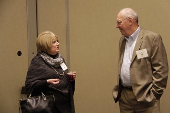 Photo of attendees visiting at the AET Reception. 