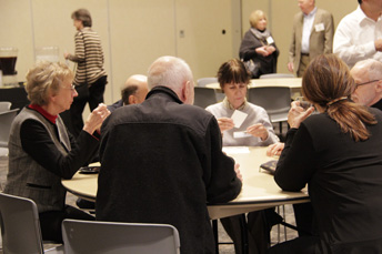 Photo of attendees visiting at the AET Reception. 