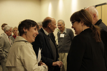 Photo of attendees visiting at the AET Reception. 