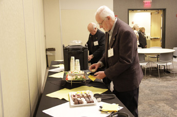 Photo of attendees getting snacks at the AET Reception. 