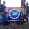 Shireen Fikree poses with other students in front of their NSE banner project. Fikreestudied at the University of North Texas through National Student Exchange.
