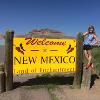 Lara Brockway poses with the Welcome to New Mexico sign. Brockway studied at the University of New Mexico through National Student Exchange.