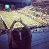 Caitlin Lee attends a UNT football game with a friend. Lee studied at the University of North Texas through National Student Exchange.