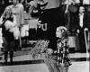 Wu holds hands with a fan during the National Anthem at Henry Levitt Arena in 1976.