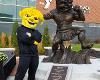 WuShock poses with a his statue in front of the Steve Clark YMCA and Student Health Center.