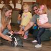 Children gather around a small penguin