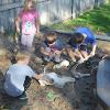 A group of children plays in the sandbox.