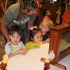 Three children observe an ant farm