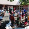 A group of children play in mud during field day.