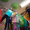 Children dance with tulle fabric.