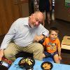 A father and son enjoy some snacks at the Child Development Center.