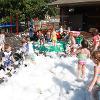 A group of children are playing in foam bubbles.