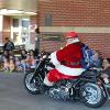 Santa Claus drives by on his motorcycle.