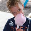 A child enjoys cotton candy.