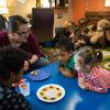 Children learn about colors and numbers using candy pieces.