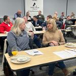 Group of Forum Members Conversing at Executive Breakfast