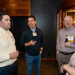 three men and a woman talking