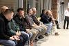 A line of people in chairs watching the presentation. 