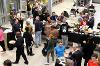 An aerial shot of people talking in groups around a refreshment table.