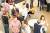 Groups of people talking around tables. 