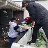 Kevin Harrison unloading food donations from a truck. 