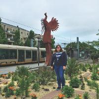 A student stands in front of Le Gardien des Plaines.