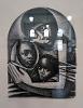 Stained glass windows are reflected in the glass of a framed lithograph that depicts a woman holding two children.