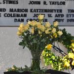 Detail shot of memorial flowers and wreath