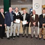 Coaching staff honorees pose with their plaques