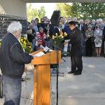 A speaker stands at the podium. You can see event attendees over his shoulder.