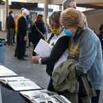 Attendees peruse old Parnassus yearbooks at the post-ceremony reception