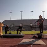 A student vocalist sings "Where Have All the Flowers Gone?" on guitar, shot horizontally