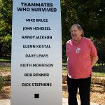 David Lewis stands by the survivor's monument