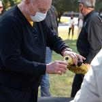 Bill Burch pours glasses of bourbon out of a WuShock decanter to toast fallen teammates