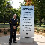 Rick Stephens stands by the survivor's monument