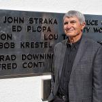 Ed Plopa stands beside his name on the black plane addition to the monument