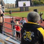 An attendee wearing a Shocker jacket waits for the ceremony to start
