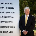 Mike Bruce stands by the survivor's monument